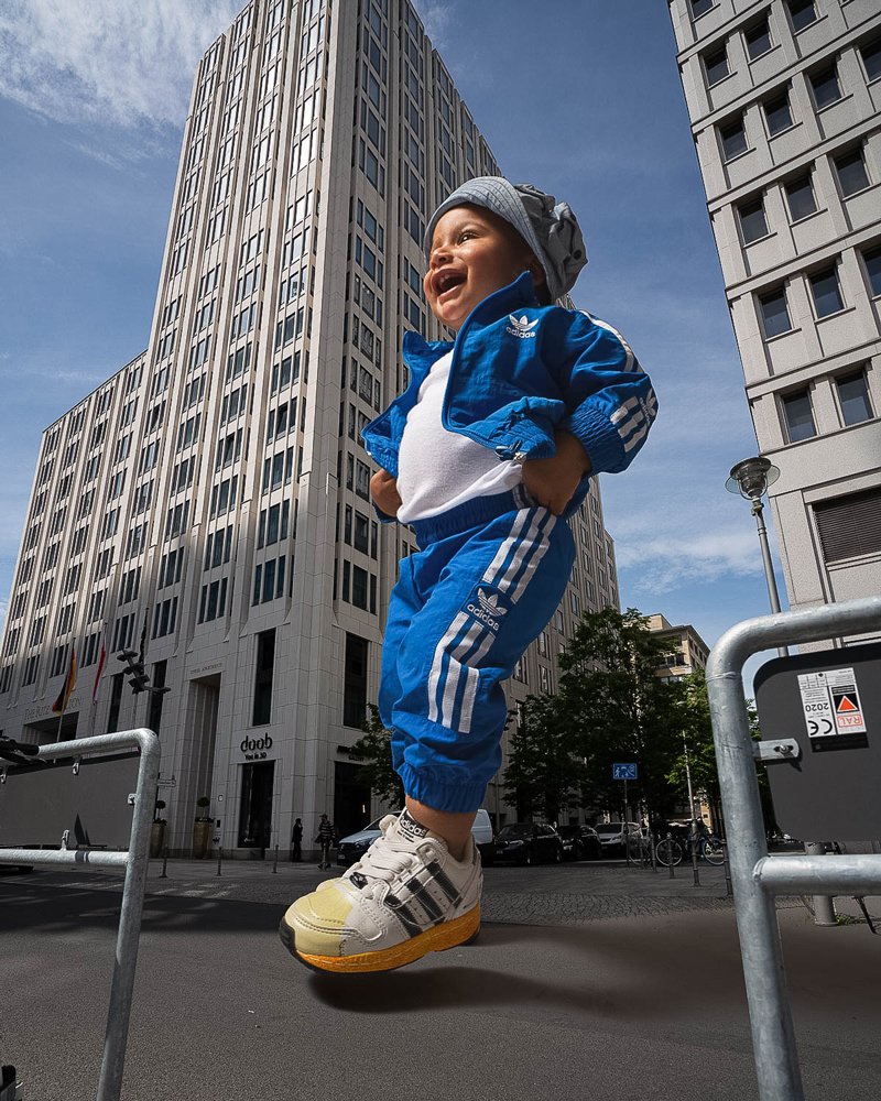 giant kid in adidas tracksuit walking on potsdamer platz station berlin